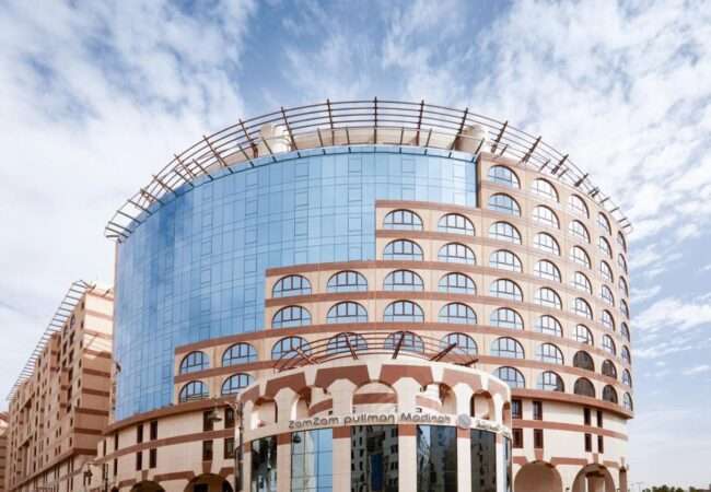 Exterior of Pullman Zamzam Madina with blue sky in background.